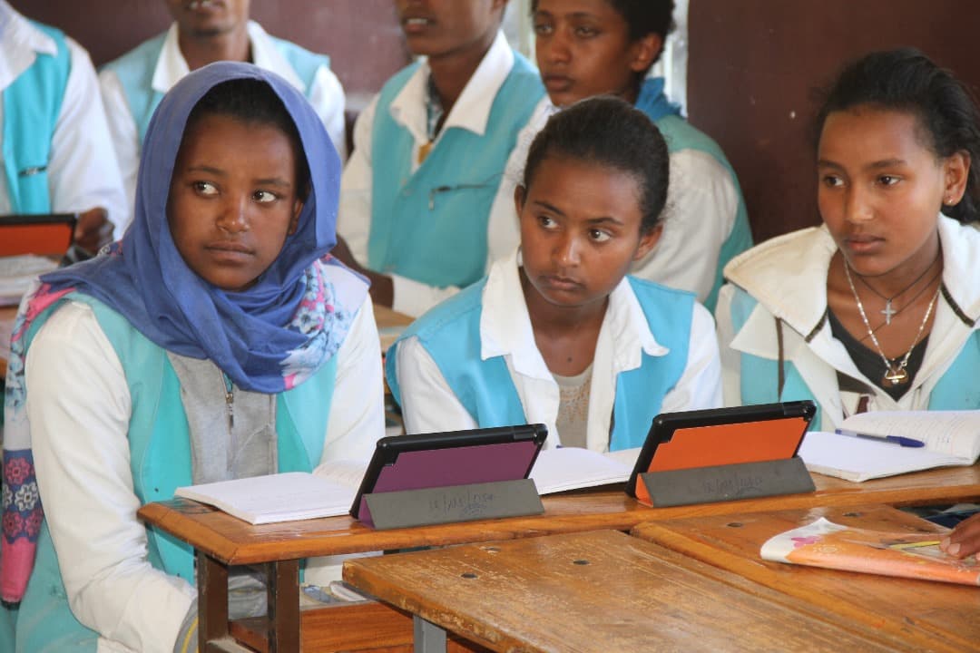 Students learning together with tablets in a classroom